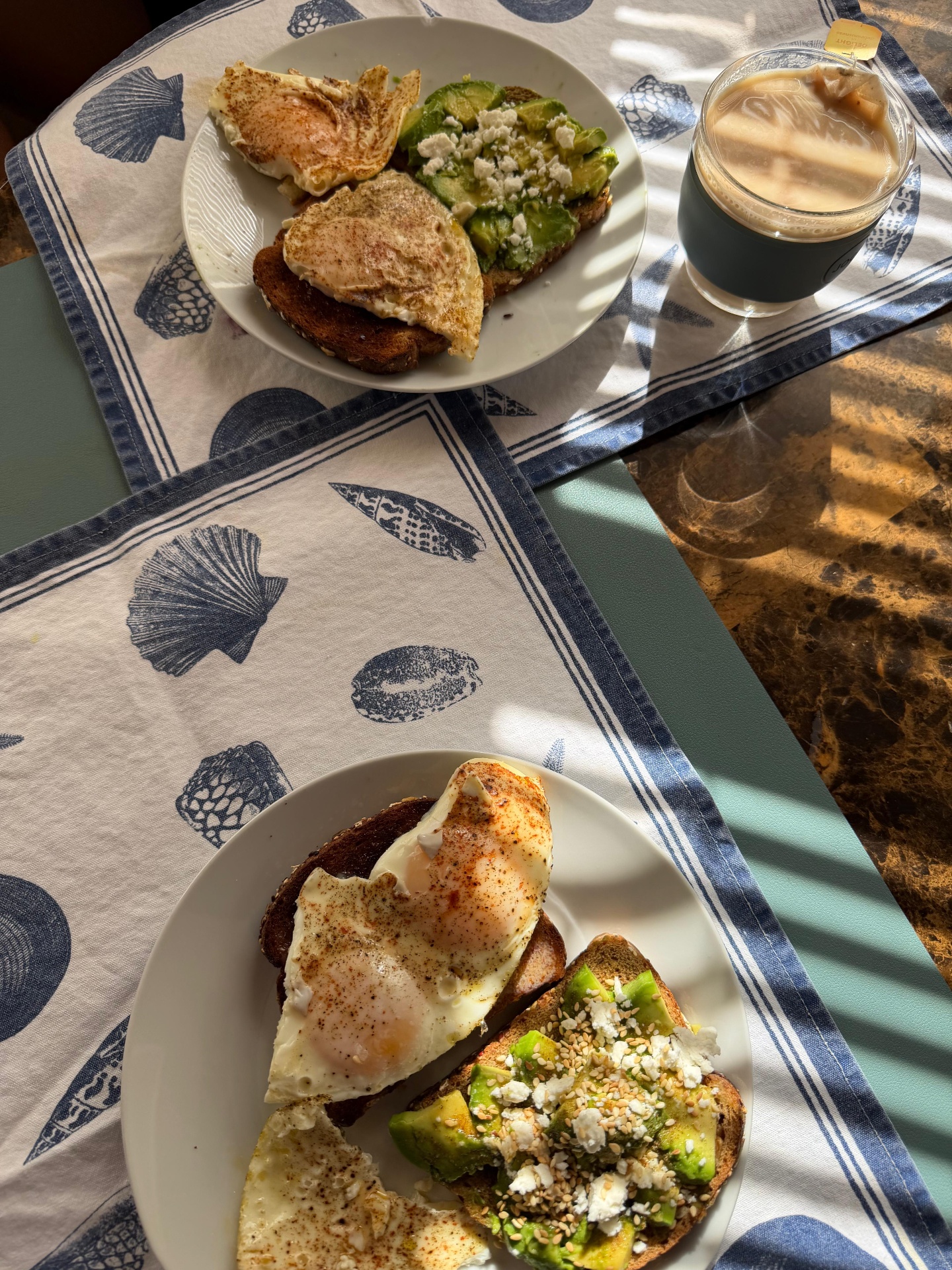 Eggs, avocado toast and coffee in morning light